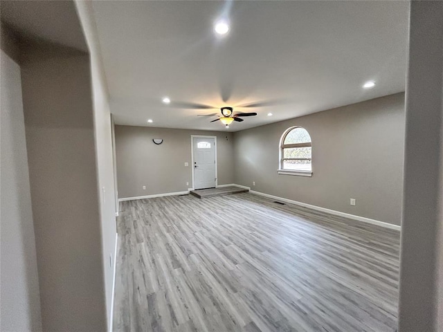 unfurnished room with ceiling fan and light hardwood / wood-style floors