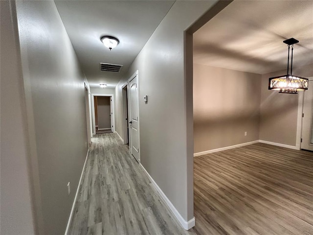 corridor featuring wood-type flooring