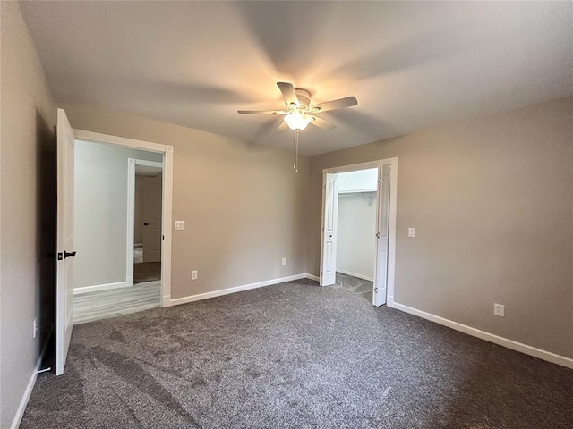 unfurnished bedroom with ceiling fan, a closet, and dark colored carpet