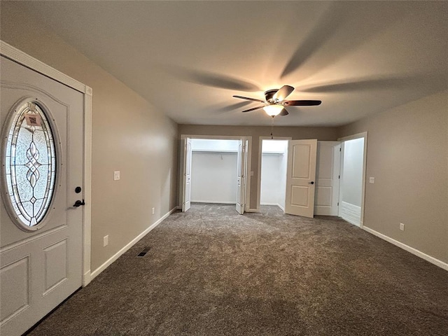 carpeted entrance foyer with ceiling fan