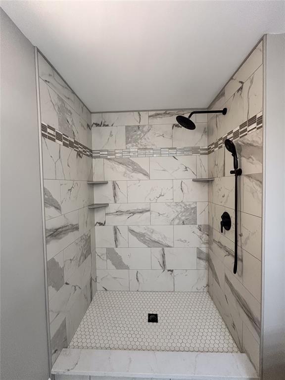 bathroom with tiled shower