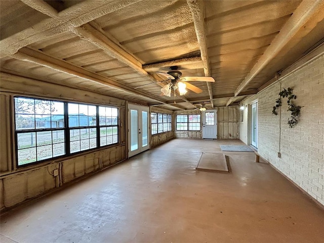 unfurnished sunroom featuring ceiling fan