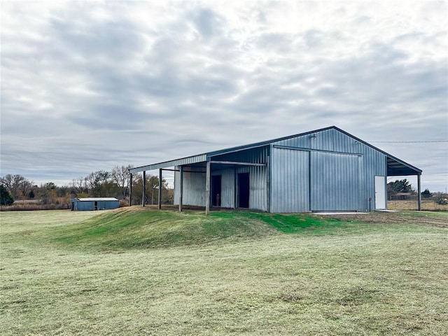 view of outdoor structure featuring a lawn