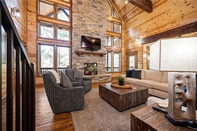 living room with hardwood / wood-style flooring, high vaulted ceiling, and a wealth of natural light