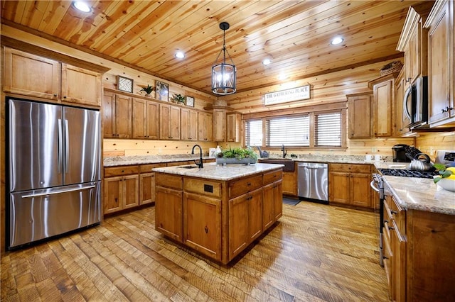 kitchen with wooden ceiling, stainless steel appliances, an island with sink, light hardwood / wood-style floors, and decorative light fixtures