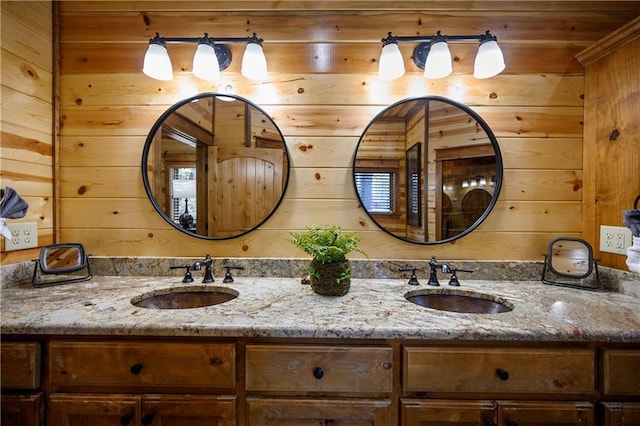 bathroom with vanity and wooden walls