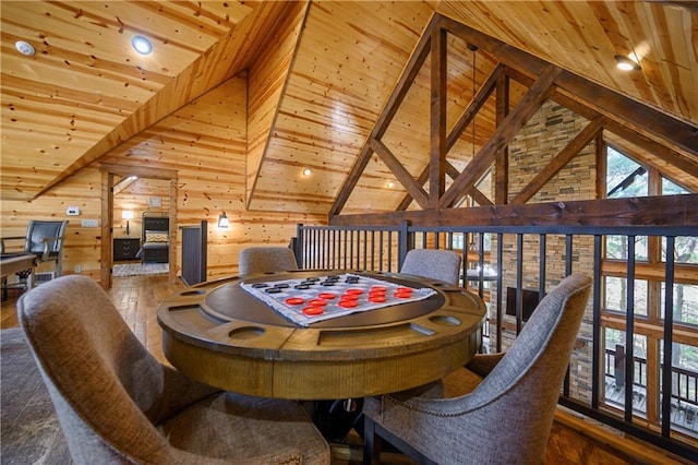 dining room with hardwood / wood-style floors, wood walls, a healthy amount of sunlight, and wood ceiling