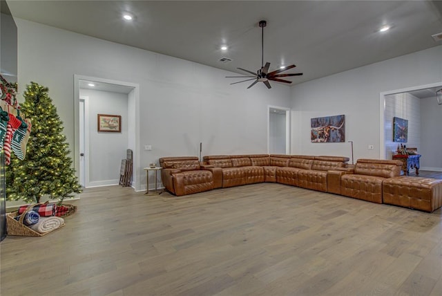 living room with ceiling fan and light wood-type flooring