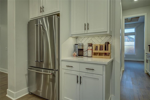 kitchen with white cabinets, decorative backsplash, dark hardwood / wood-style floors, and high end fridge