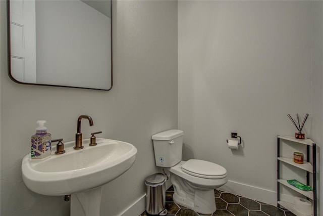 bathroom with tile patterned floors, toilet, and sink