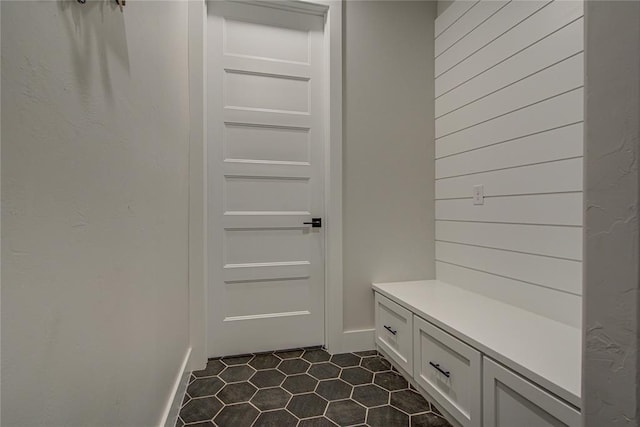 mudroom featuring dark tile patterned floors