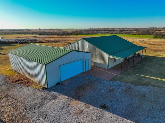 view of outbuilding featuring a rural view and a garage