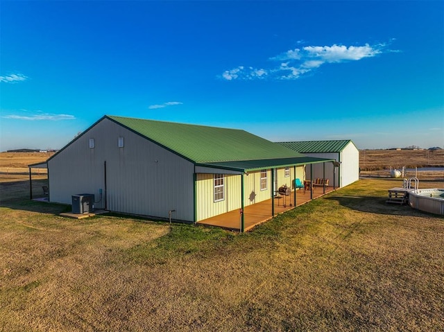 view of side of property with a yard and central air condition unit