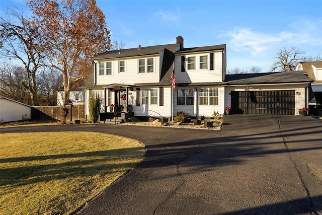 view of front of house featuring a garage and a front lawn