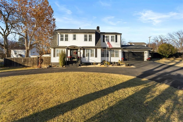 view of front facade featuring a front yard and a garage