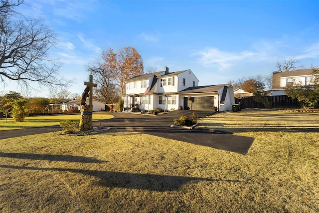 view of front of home featuring a garage and a front lawn