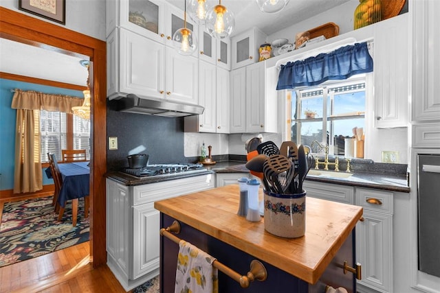 kitchen with white cabinets, hardwood / wood-style floors, and decorative backsplash