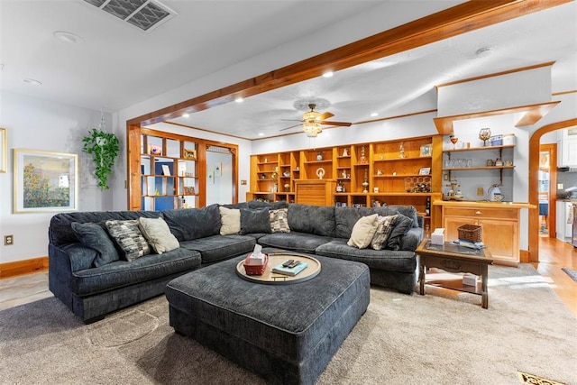 living room featuring ceiling fan, beamed ceiling, and light wood-type flooring