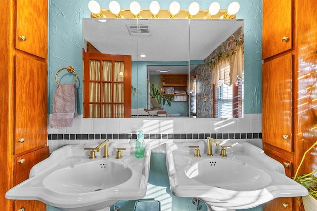 bathroom featuring sink and a textured ceiling