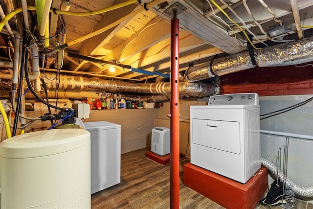 interior space with independent washer and dryer and hardwood / wood-style flooring