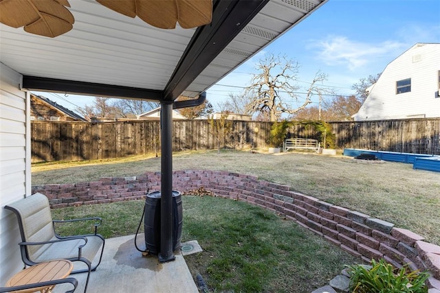 view of yard featuring ceiling fan and a patio area