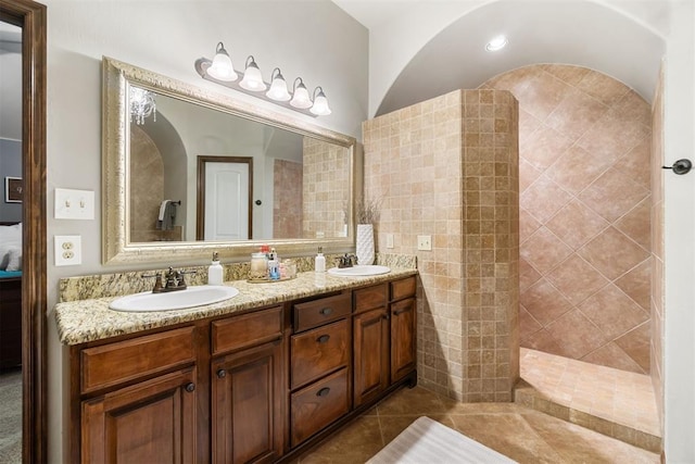 bathroom with tile patterned flooring, vanity, and tile walls