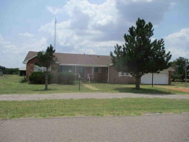 ranch-style house featuring a garage and a front yard