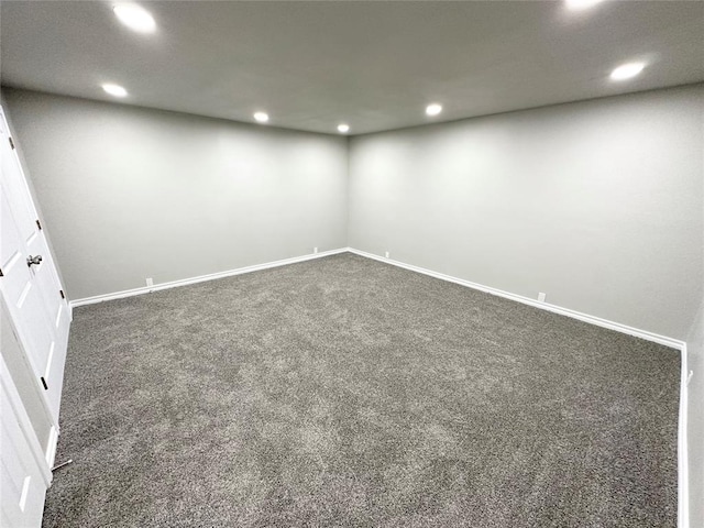 spare room featuring dark carpet