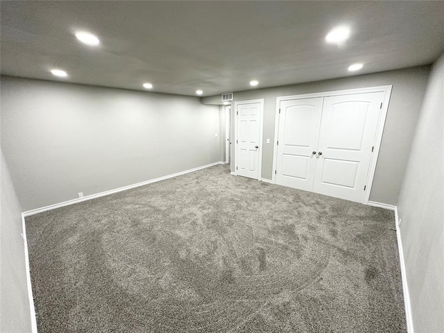 basement featuring dark carpet