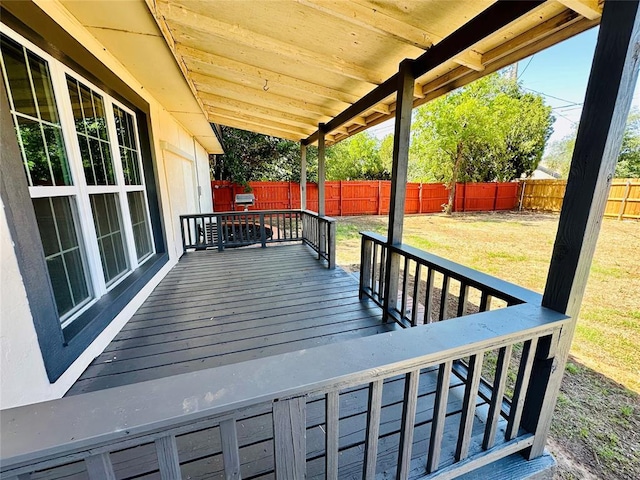 wooden terrace featuring a lawn