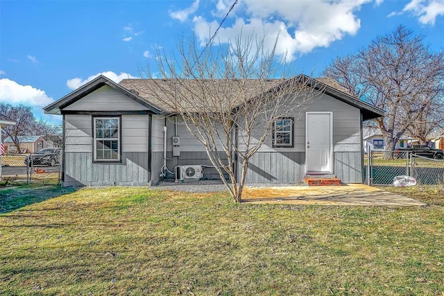 rear view of property with ac unit and a lawn