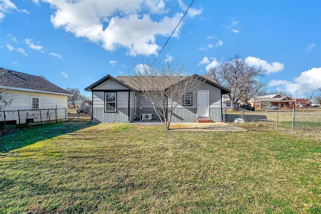 rear view of property with a lawn