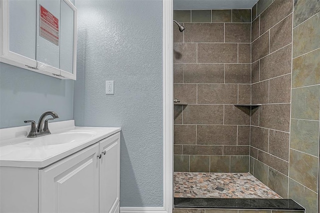 bathroom featuring vanity and a tile shower