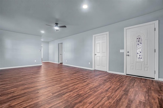 spare room featuring ceiling fan and dark wood-type flooring