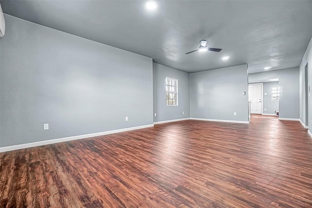 empty room with dark hardwood / wood-style flooring and ceiling fan