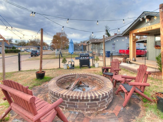 view of patio / terrace with a fire pit and a grill