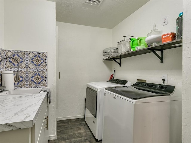 laundry area with washer and clothes dryer and dark hardwood / wood-style flooring