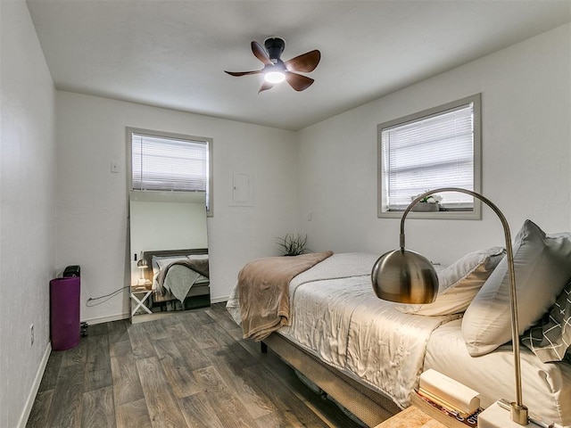 bedroom with multiple windows, ceiling fan, and dark wood-type flooring