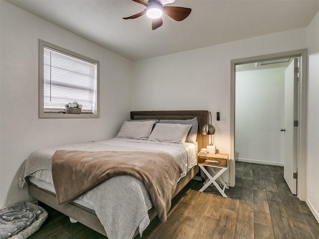 bedroom with ceiling fan and dark wood-type flooring