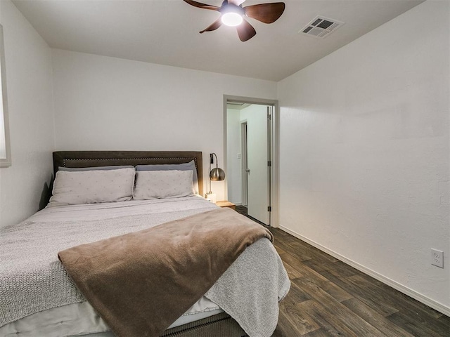 bedroom with dark hardwood / wood-style floors and ceiling fan