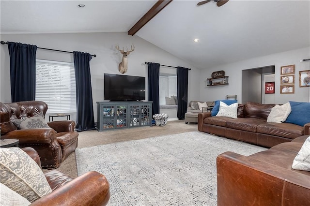 carpeted living room featuring ceiling fan and lofted ceiling with beams