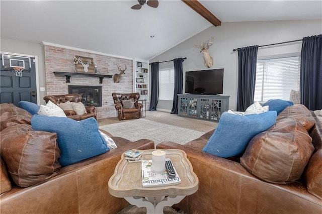 carpeted living room with vaulted ceiling with beams, a healthy amount of sunlight, a fireplace, and ceiling fan