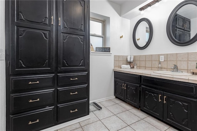 bathroom featuring tile patterned flooring, vanity, and tasteful backsplash