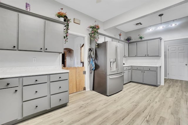 kitchen featuring gray cabinetry, decorative light fixtures, stainless steel refrigerator with ice dispenser, and light hardwood / wood-style floors