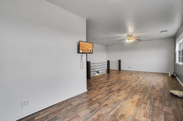 empty room with hardwood / wood-style flooring and ceiling fan