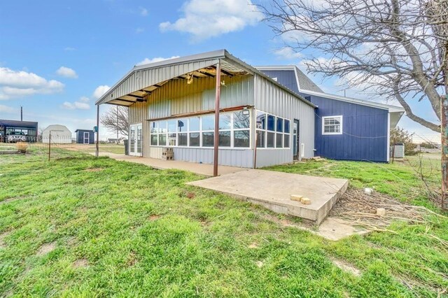 rear view of property with a yard