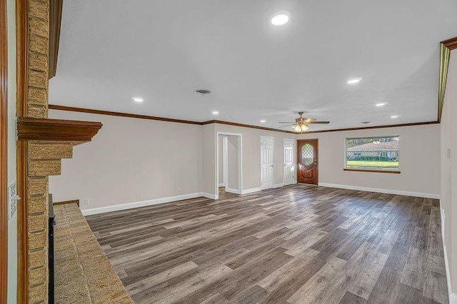 unfurnished living room with hardwood / wood-style floors, ceiling fan, and crown molding