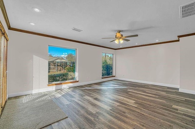 empty room featuring ceiling fan, crown molding, and dark hardwood / wood-style floors