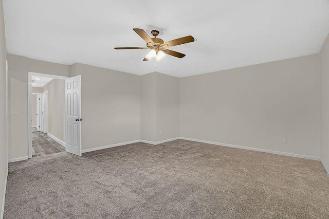 empty room with ceiling fan and light carpet