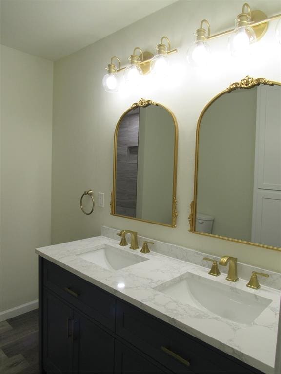 bathroom featuring hardwood / wood-style floors, vanity, and toilet